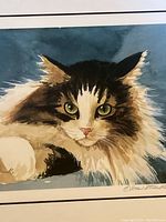Close-up image showing the detailed cat portrait, emphasizing the texture and color of the fur and eyes.