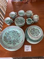 Full view of teal dish set with cups, plates, creamer, sugar bowl showing overall pattern and contents