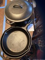 Photo showing the cast iron Dutch oven with lid and one of the skillets