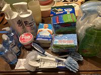 Photo of the overall cleaning supplies including hand soaps, magic erasers, sponges, brushes, and sprays