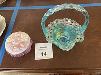 Photo showing both Fenton art glass items: teal basket and pink covered trinket dish