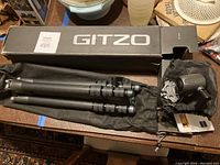 Gitzo box, folded tripod, tripod carrying pouch and ball head in pouch
