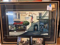 Full view of framed serigraph showing street scene