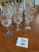 Photo showing nine Waterford crystal wine glasses arranged closely, exhibiting the detailed cut work and clear crystal craftsmanship.