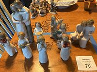 All nine resin figurines arranged on table to show full lot composition