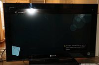 Front view of the Sony Bravia LCD TV showing screen and bezel, displaying input selection screen with no signal message.