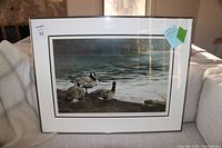 Framed print showing three Canada geese by the water, titled 'The Meeting Place'