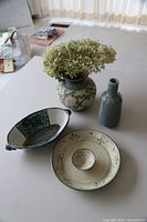 Four assorted green pottery pieces on a surface, showing all items together