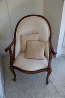 Front view of the hardwood occasional chair showing upholstery, cushions, and frame