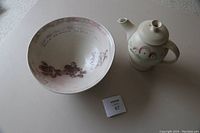 Photo of the pottery teapot with lid removed, showing spout, handle, and body design.