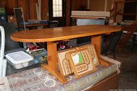 Small wooden coffee table with natural wood finish, visible grain, and sturdy base supporting top