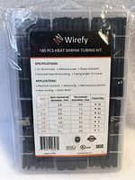 Photo of the front label on the kit case showing brand Wirefy, specifications, shrink ratio 3:1, adhesive lined, flame retardant, tubing length 3.5 inches, and size/quantity details.
