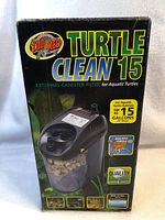 Front side of the black box for the Turtle Clean 15 filter, shows the image of the product and key features for aquatic turtle setup up to 15 gallons