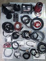 Full view of all cables, amplifier, and microphones arranged on cloth.