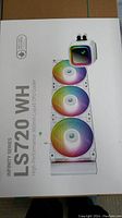 Box front showing product branding, model (LS720 WH), 360mm liquid CPU cooler with three RGB fans and pump unit.