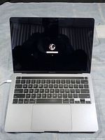 Open MacBook Pro showing network selection screen with globe icon