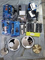Overview of all trimmers, mirrors, chargers and accessories laid out