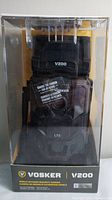 Front view of the Vosker V200 camera in clear plastic packaging showing model name and cellural LTE branding.