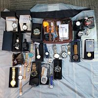 Overview of all wristwatches and tool kit laid out on surface