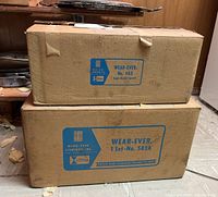 Two original boxed sets of Wear Ever cookware stacked, showing model numbers and Wear Ever Aluminum, Inc. branding on cardboard boxes.