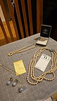 Photo showing three pearl necklaces, blue bobble necklace and matching clip earrings, plus note stating 'Made in Germany'