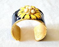 Front and interior view of blue and yellow enamel bangle cuff bracelet with large floral design