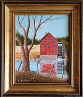 Frontal view of framed painting showing red watermill scene and gold-tone wood frame