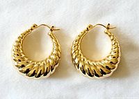 Pair of gold-plated twisted hoop earrings shown flat on white background.