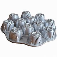Angled side view of Nordic Ware rose muffin pan showing 12 rose-shaped molds and scalloped edges.