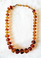 Full view of necklace laid flat showing bead arrangement and clasp