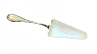 Top view of the sterling silver cake server showing the detailed floral scroll handle and triangular shaped blade with a slight notch on the edge.