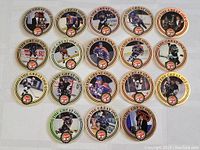 Full lot of 18 Wayne Gretzky Coca-Cola promotional pogs arranged flat showing all designs including holographic and non-holographic edges.