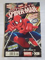 Front cover of Ultimate Spider-Man comic showing Spider-Man and promotional text.
