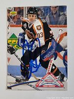 Front of Doug Gilmour hockey card signed in blue ink, showing the player in NHL All-Star 1994 jersey.