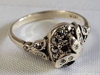 Close-up image of vintage sterling silver ring showing detailed Art Nouveau heart and floral design with marcasite stones.