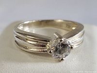 Close-up of the sterling silver ring with round solitaire clear stone in six-prong setting.