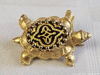 Close-up top view of the vintage gold plated turtle brooch pin showing the decorative enamel shell.