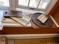 Overall view of the six cutting boards in various sizes and shapes including round and rectangular ones.