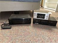 All three components and remote laid out on carpet