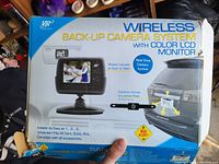 Box showing the VR3 Wireless Back-Up Camera System with Color LCD Monitor, includes monitor and rear view camera mounts, with visible box wear damage.