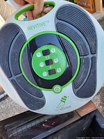 Photo of the Revitive IX Isorocker circulation booster device showing the front with footpads and control panel.