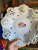 Top view of porcelain plate showing floral design and gold accents