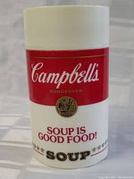 Close-up photo of the Campbell's Soup thermos showing the iconic red and white label and gold medallion with 'Soup is Good Food!' slogan.