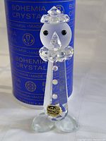 Close-up photo of Bohemia Crystal clown figurine with original sticker attached, showing detailed facial features and crystal collar, with packaging in the background.