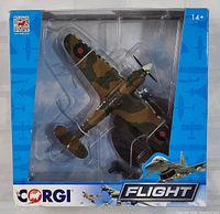 Front view of boxed Corgi Hawker Hurricane model in blue packaging with clear plastic window showing camouflage painted plane and display stand.