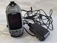 Magellan eXplorist 500 GPS device with attached power cord and visible bike mount.