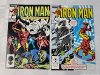 Photo showing both Iron Man comic books: issue #190 with cover featuring Iron Man and The Scarlet Witch, and issue #194 with Iron Man battling a silver robot.