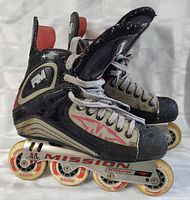 Pair of Mission Detonator RM inline hockey skates size 8 displayed side by side showing the side profile with four white 80mm wheels, laces, and scuffed surfaces.