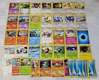 Photo showing layout of 39 assorted Pokemon cards including character, trainer, and energy cards.