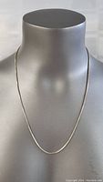 Front view of a fine sterling silver necklace on a mannequin bust.